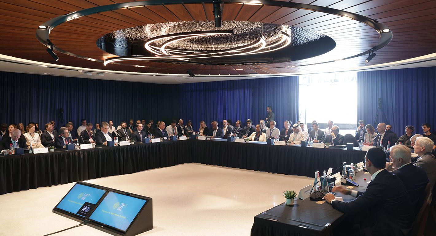 Conference attendees engaged in a roundtable discussion