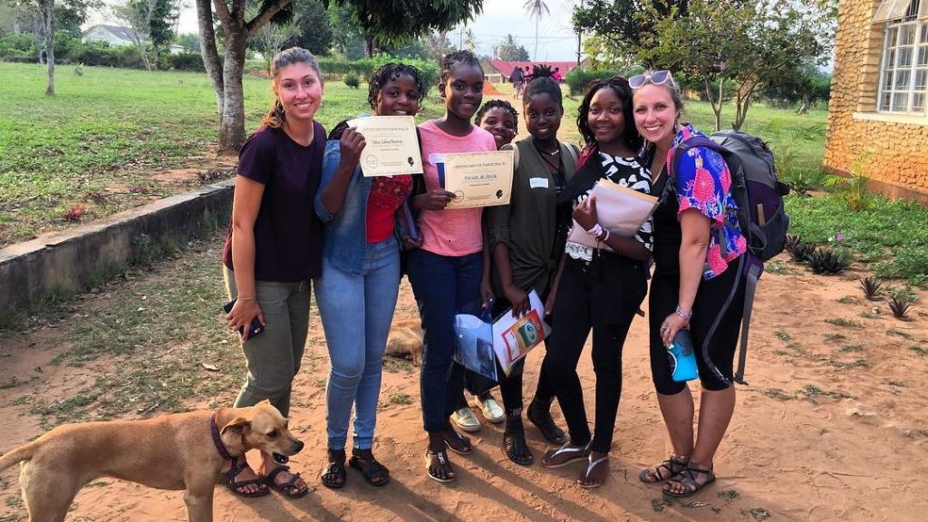 A photo of Katy Blackmer with a group at the Girls Empowerment Camp in 2018