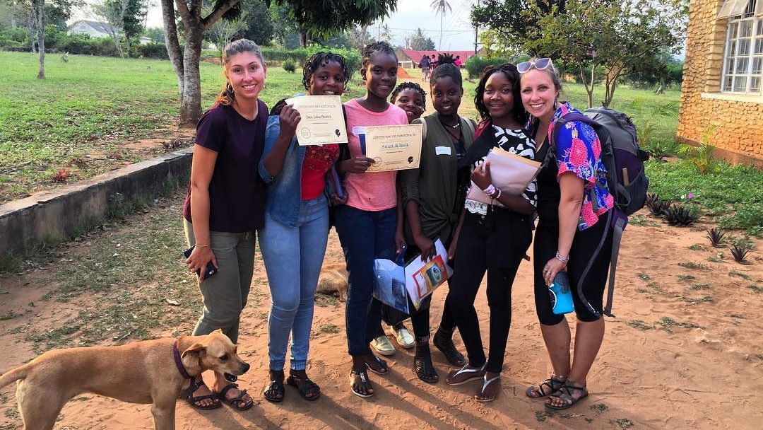 A photo of Katy Blackmer with a group at the Girls Empowerment Camp in 2018